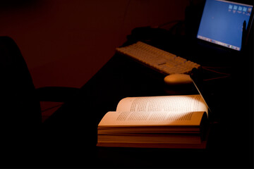 cell phone and power bank on the desk illuminates reading and study book with battery-powered...