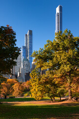 Central Park in Fall with the skyscrapers of Billionaires Row. Midtown Manhattan, New York City - obrazy, fototapety, plakaty