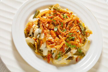 cheesy green bean casserole on plate, top view