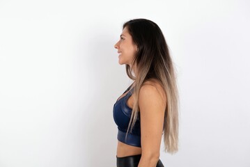 Profile portrait of nice young beautiful woman wearing sportswear over white background look empty space toothy smile