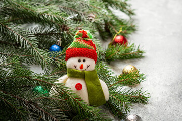Fototapeta na wymiar Christmas composition with snowman and green branches decorations balls sale