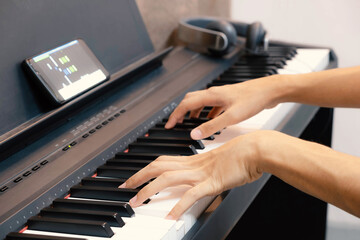 Fototapeta premium Hands of teenager boy playing electric piano