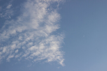Background. Beautiful, blue skies during the daytime with beautiful, light, airy feather-like clouds. Desktop wallpaper. Beautiful, natural. Nature. Freedom. Sky path from air clouds. copy space