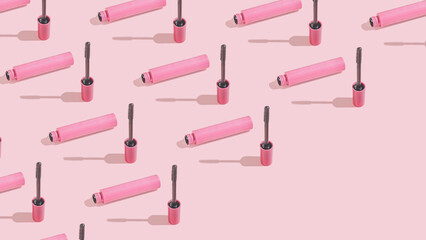 Creative pattern with mascara brush on sunny pink background. Diagonal copy space. Cosmetic studio...