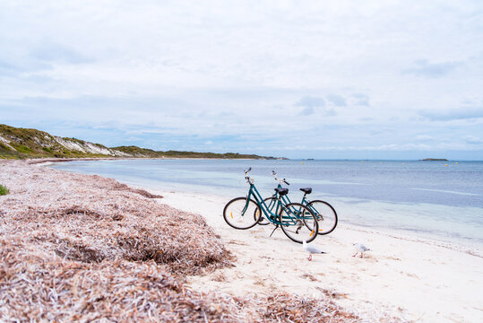 Two Bicycles Parked On A Beach On Rottnest Island, Western Australia. Bike Rental For Tourists. Scenic View