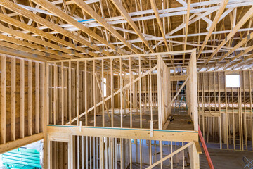 During construction new residential property, one can see the wooden framing home on construction site.