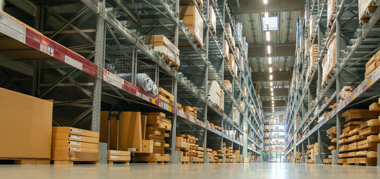 Panoramic view of a large warehouse in the aisle between shelves and racks