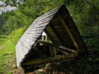 Old wooden gazebo near the forest