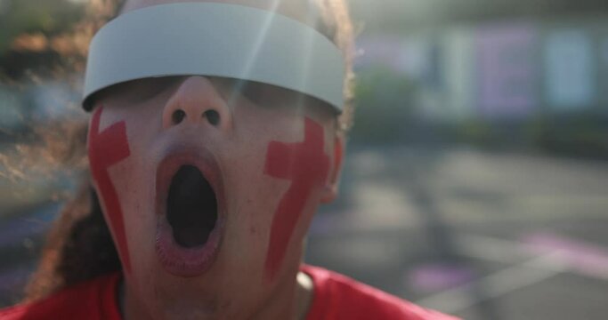 African red sport fan watching using futuristic augmented reality glasses during football match out of the stadium