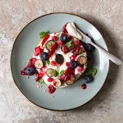 plate with bagel with cream cheese and berries on the table