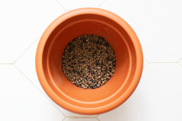 Brown flowerpot with expanded clay for planting