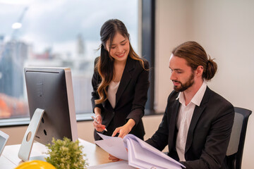 Senior team leader of group of startup business co-worker working in office look at laptop computer help explanation unclear assignment to new comer employee