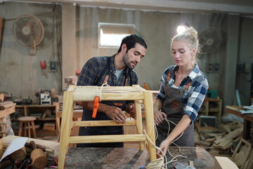 Contemporary Carpenter Working, Portrait of modern carpenter making wood furniture while working in joinery lit by sunlight with factory background on small business concept, copy space