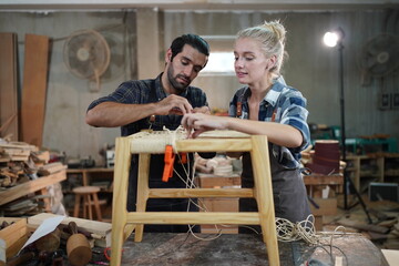 Contemporary Carpenter Working, Portrait of modern carpenter making wood furniture while working in joinery lit by sunlight with factory background on small business concept, copy space