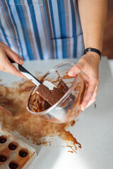 Woman the chef prepares chocolate sweets. Homemade delicious sugar dessert. Healthy food
