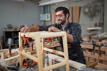 Contemporary Carpenter Working, Portrait of modern carpenter making wood furniture while working in...