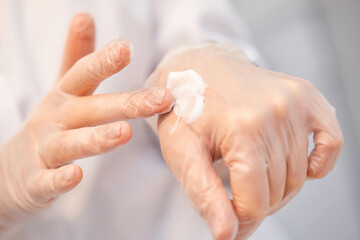 beautician in gloves shows the texture of the cream
