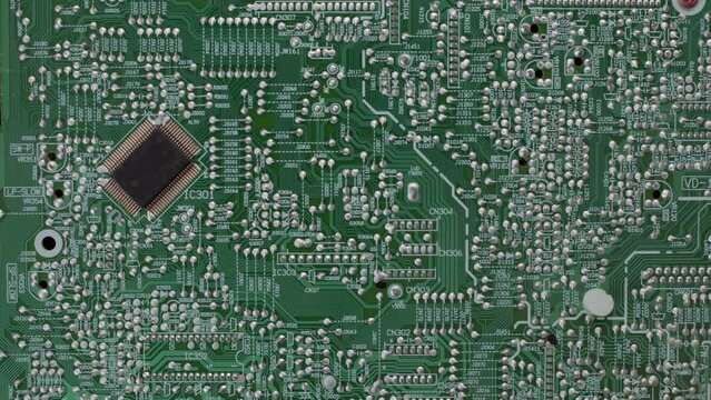 top down view of green microchip of complex equipment. Many soldered paths along which information passes. concept of various electronic devices, disassembled equipment.