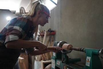 Contemporary Carpenter Working, Portrait of modern carpenter making wood furniture while working in joinery lit by sunlight with factory background on small business concept, copy space