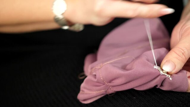 Video describe sew a button to a dress. That video was created in the sewing service studio. Seamstress do it with the passion and precisely.