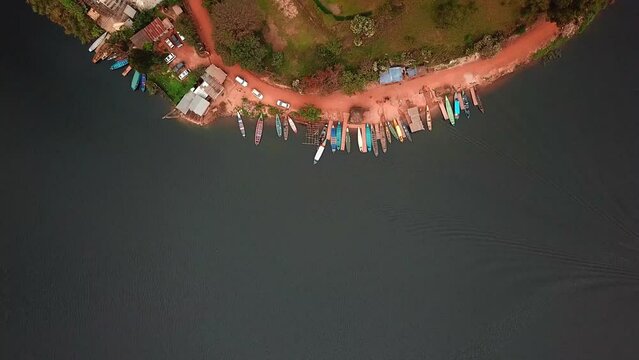 Top View Of Wooden Fishing Boats Docked On The Shore Of Lake Bunyonyi, Uganda. Aerial Shot