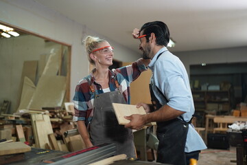 Contemporary Carpenter Working, Portrait of modern carpenter making wood furniture while working in joinery lit by sunlight with factory background on small business concept, copy space