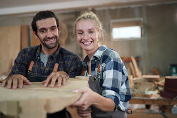 Contemporary Carpenter Working, Portrait of modern carpenter making wood furniture while working in joinery lit by sunlight with factory background on small business concept, copy space