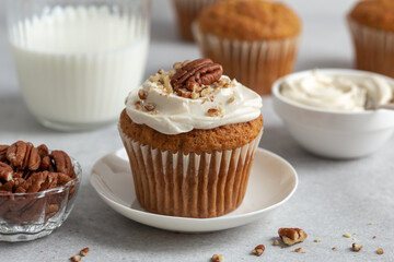 carrot cupcake with nuts and  cream cheese frosting