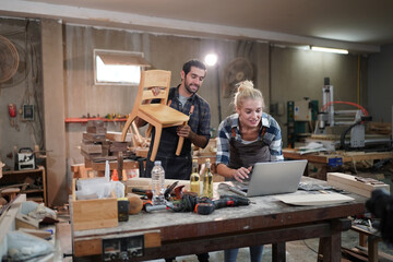 Contemporary Carpenter Working, Portrait of modern carpenter making wood furniture while working in joinery lit by sunlight with factory background on small business concept, copy space