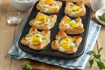 savory puff pastry cups with egg and cheese - 537519233