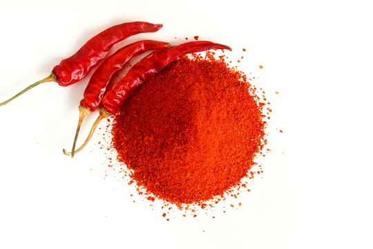 heap of dry organic kashmiri red chili pepper and chili pepper powder isolated on white  background selective focus,well known for dark red color food recipe  in indian gujarati food
