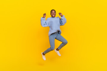 Fototapeta na wymiar Full size photo of optimistic young nice lady jump wear blue sweater jeans sneakers isolated on grey color background