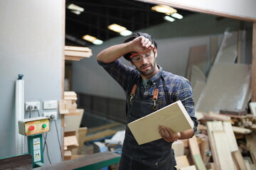 Contemporary Carpenter Working, Portrait of modern carpenter making wood furniture while working in...