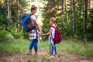 Mother and daughter enjoy hiking together.	
