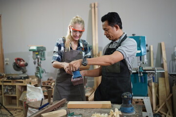 Contemporary Carpenter Working, Portrait of modern carpenter making wood furniture while working in joinery lit by sunlight with factory background on small business concept, copy space