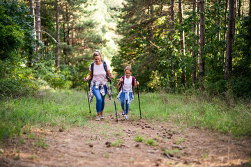 Mother and daughter enjoy hiking together.	