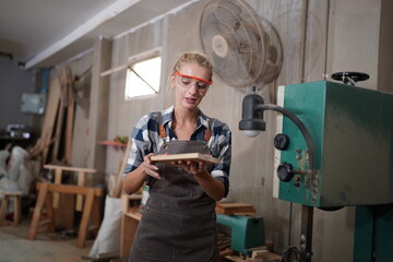 Contemporary Carpenter Working, Portrait of modern carpenter making wood furniture while working in...