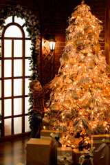 Christmas tree magically glows with New Year's orange lights, a little boy decorates it