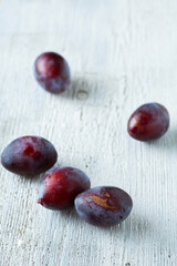 group of ripe plums  on an old cutting board