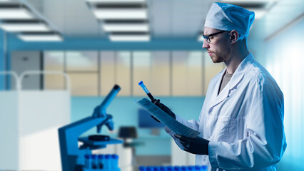 Geneticist is holding blood sample. Male geneticist in white coat. Genetic laboratory employee....