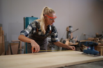 Contemporary Carpenter Working, Portrait of modern carpenter making wood furniture while working in...