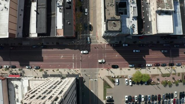 Overhead drone view of downtown Flint, Michigan with cars driving on corner.
