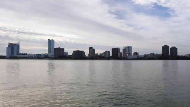 Windsor, Ontario Canada skyline with Detroit River recorded from Detroit, Michigan with stable video.