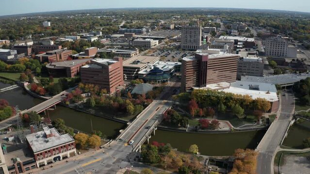 Flint, Michigan Skyline Along With Flint River On Wide Shot Up High Drone Video Moving Sideways.