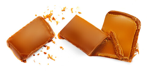 Creative layout made of Caramel candies with caramel sauce isolated on a white background Flat lay. Food concept.