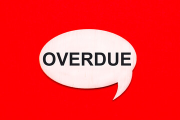 On a bright red background, a light wooden curly card with the text OVERDUE