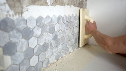 Tiles of natural color hexagons stacked together like a wall, abstract background texture. Laying...
