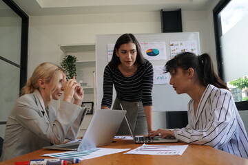 Obraz premium Creating workplace synergy. Shot of a group of young designers working together in an office.