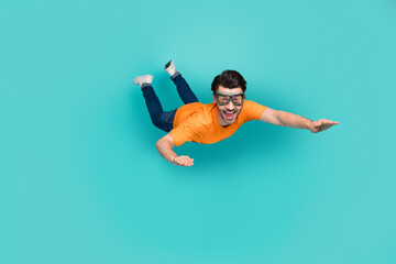 Full length photo of carefree sporty guy trying skydive falling down isolated on cyan color...