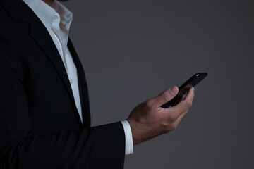 Young businessman holding a mobile phone to search the internet with a smartphone. Business concept, education, lifestyle.